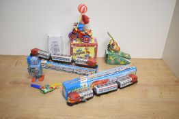 Two Chinese made tin-plate wind-up express trains, each with original printed card packaging, sold
