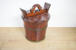 An early 20th century stained, coopered and lidded wooden rice bucket, of traditional design, 31cm x
