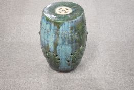 A Chinese mottled/dripped green glazed pottery garden seat, of typical barrel form with pierced