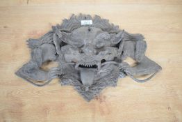A Tibetan/Nepalese cast bronze temple guardian, formed as a grotesque mask 42cm