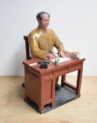 A large Chinese Maoist/cultural revolution porcelain figure of Chairman Mao seated at his desk, 40cm