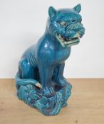 An unusual Chinese turquoise glazed pottery study of a large cat or panther, modelled seated with