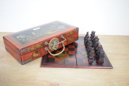 A modern Chinese chess set, having a folding dragon design board and a complete set of cast resin