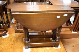 A vintage oak drop leaf occasional table, width approx. 61cm