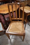An Arts & Crafts (possibly Arthur Simpson Handicrafts) style golden oak dining chair, having drop in