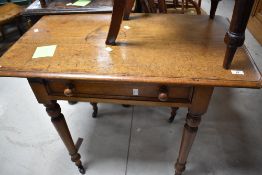 A Victorian oak side table having canted top, frieze drawer and turned legs, approx. dimensions