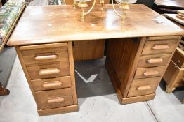 An early 20th Century oak desk, width approx. 122cm