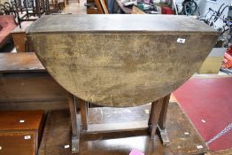 An early to mid 20th Century dark stained Sutherland style dining table