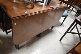 A 19th Century mahogany drop leaf dining table, width approx. 129cm, closed depth 53cm