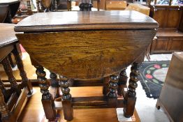 A nice quality reproduction oak drop leaf occasional table, possibly Titchmarsh and Goodwin, width