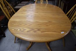 A modern Ercol extending dining table, approx. 146 x 103cm, including leaf