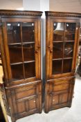 A pair of Titchmarsh & Goodwin reproduction corner display cabinets, design RL23044 (right and