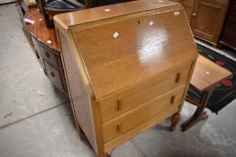 A mid 20th Century golden oak bureau