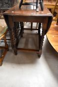 An early to mid 20th Century oak twist gate leg dining table