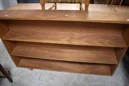 A vintage teak bookshelf of plain design, dimensions approx. W156 H89 D22cm