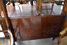A George III mahogany drop leaf dining table, of rectangular form, with gated and butterfly