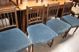 A set of 19th Century oak chairs having architectural style rail backs and overstuffed seats