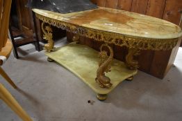 A vintage Onyx and gilt coffee table of oval form with shaped undertier