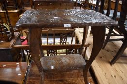 An early to mid 20th Century side table having carved top and undertier
