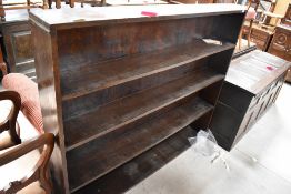 An early 20th Century dark stained bookshelf, dimensions approx. W152 H130 D21cm