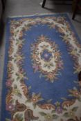 A modern wool fireside rug having blue floral pattern, approx. 156 x 90cm