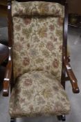 A traditional oak framed rocking chair, in the Victorian style