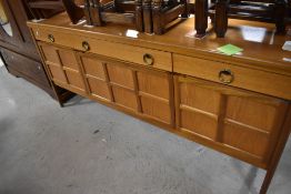 A vintage teak sideboard, possibly Nathan , having squares style to cabinet doors, and central