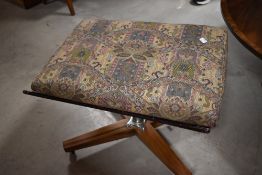 A vintage teak swivel stool
