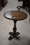 A reproduction oak pedestal occasional coffee table