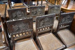 A set of eight 19th Century cane seated bedroom chairs having interesting embossed leather backs ,