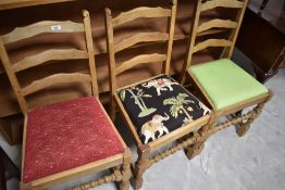 A set of four (three plus one) ladderback dining chairs , having drop in seats in three different
