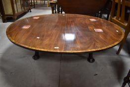 An oversized coffee table haviing Regency style top