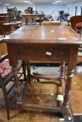 An early 20th Century oak occasional table having square top and turned legs , with carved frieze,