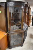 An early 20th Century mahogany corner display , having astral glazed upper and lower sections ,