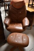 A vintage tan leather swivel chair and footstool (similar to Stressless)