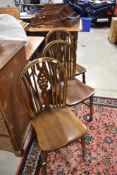 A vintage set of three wheelback kitchen dining chairs