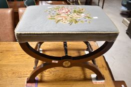 A Savonarola style stool having tapestry top