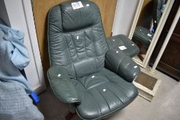 A vintage green leather swivel chair and footstool (similar to Stressless)