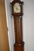 A modern mahogany effect long case clock , having triple weights