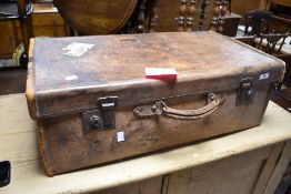 A vintage leather travel case, having several railway labels etc attached