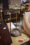 A brass umbrella stand , in the Victorian style