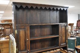 A period oak dresser having delft rack over two drawer base, on cabriole legs, width approx. 136cm