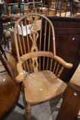 A traditional Windsor chair having natural finish