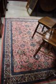 A modern Persian style rug, having pink ground with foliate pattern, approx. 195 x 130cm