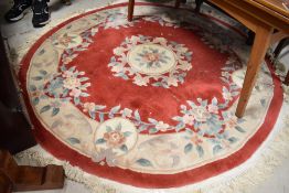A circular Chinese rug, having red ground, with foliate decoration, diameter approx. 170cm,