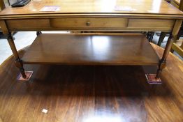 A reproduction yew effect coffee table having frieze drawer and shelved undertier