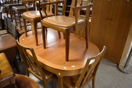 A vintage G plan or similar teak oval dining table and set of six (four plus two) similar dining
