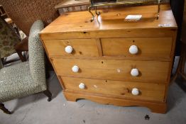 A vintage pine chest of two over two drawers, in the Victorian style having pot handles, width