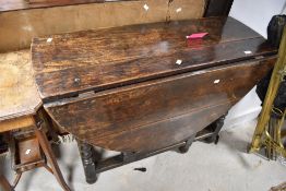 A period oak table having twist gateleg , approx width 107cm, closed depth 43cm