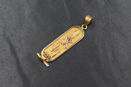 An Egyptian yellow metal hieroglyphic pendant spelling Eilyn, approx 2.5g